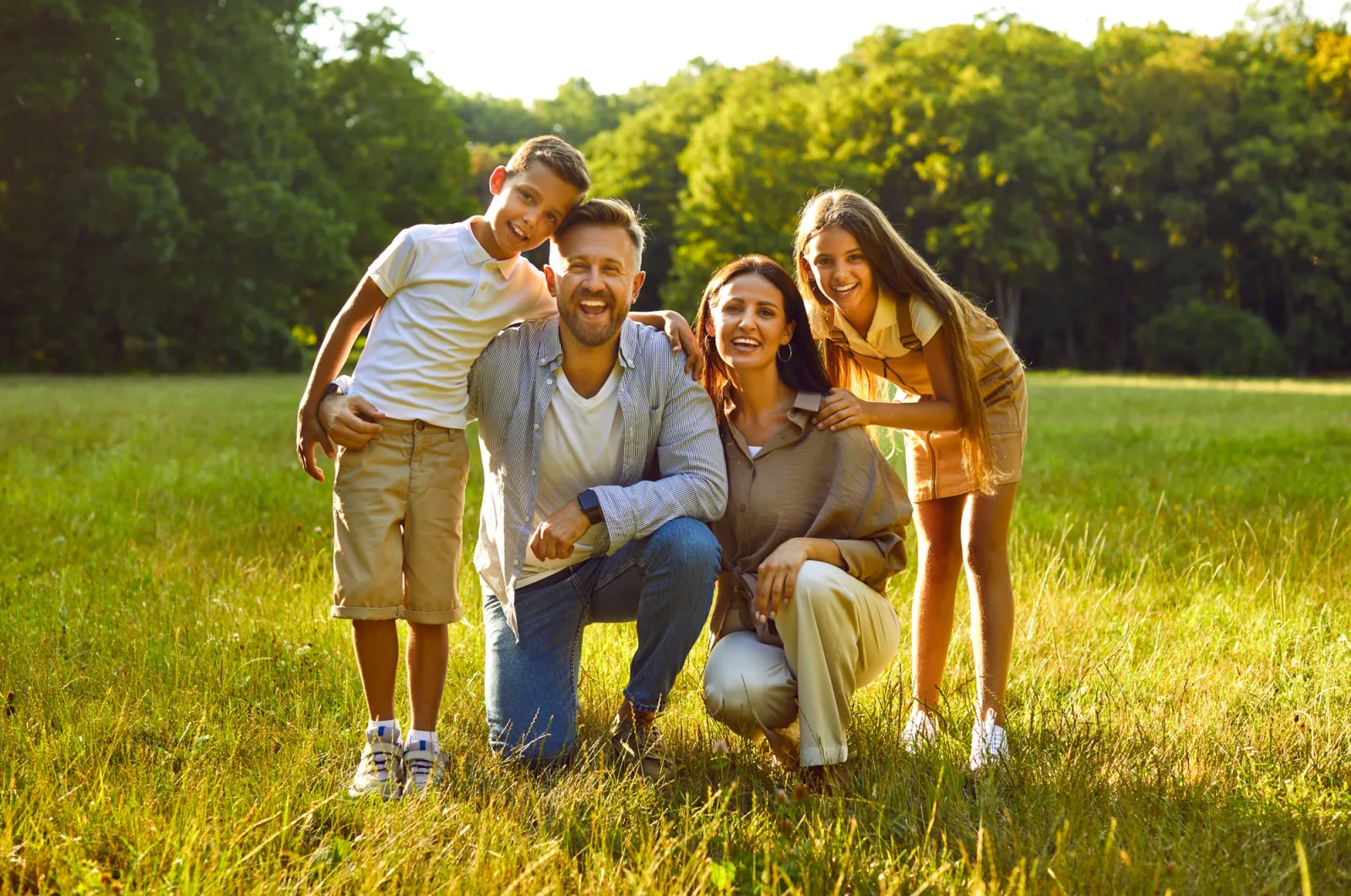 A family smiling together outdoors